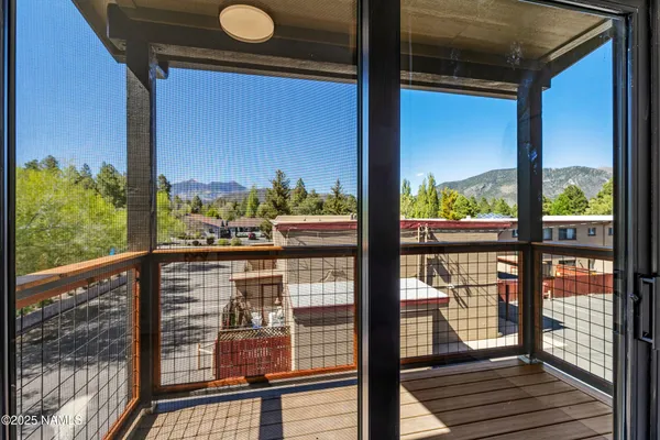 a view of a balcony with wooden floor