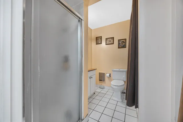 a bathroom with a toilet and a shower