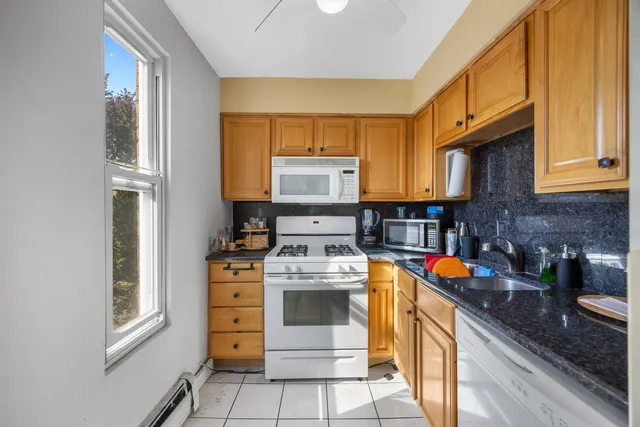 a kitchen with stainless steel appliances granite countertop a stove and a refrigerator