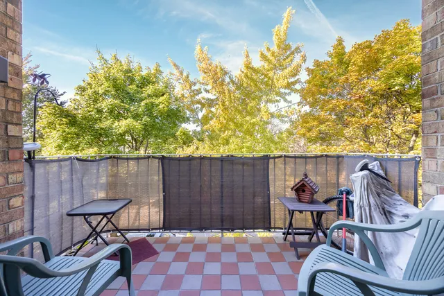 a balcony with table and chairs