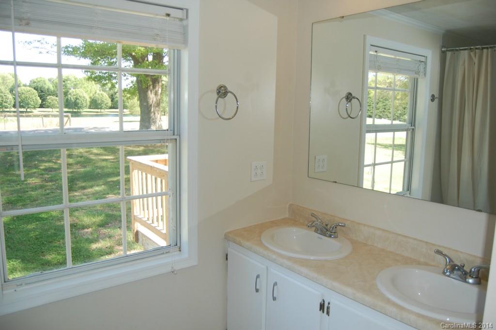 4015 Love Mill Road Monroe, NC 28110 - Photo 14 of 19 a bathroom with a sink vanity mirror and a bathtub
