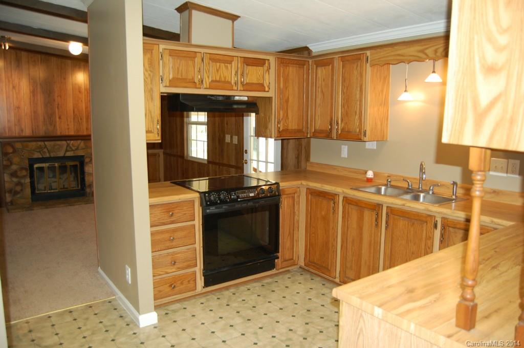 4015 Love Mill Road Monroe, NC 28110 - Photo 16 of 19 a kitchen with stainless steel appliances granite countertop a sink stove and refrigerator