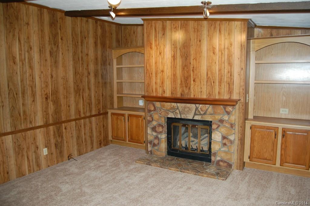 4015 Love Mill Road Monroe, NC 28110 - Photo 9 of 19 a view of an empty room with a fireplace and a window