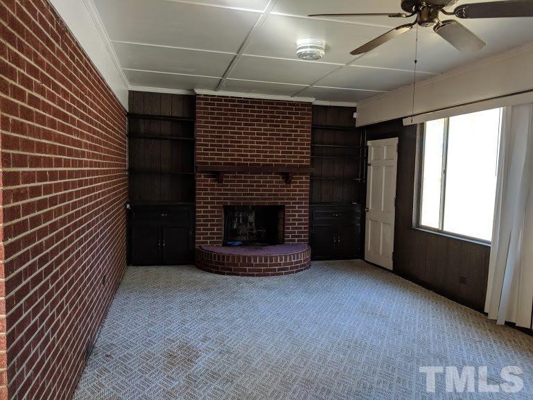 142 Evergreen Road Clarksville, VA 23927 - Photo 5 of 25 a view of an empty room with a fireplace and a window