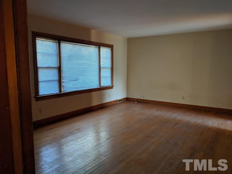 142 Evergreen Road Clarksville, VA 23927 - Photo 9 of 25 an empty room with wooden floor and windows
