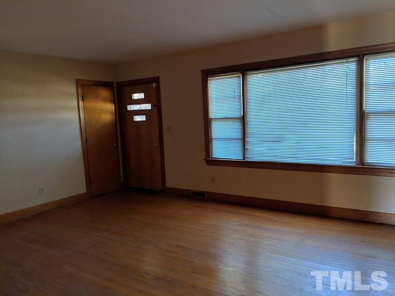 142 Evergreen Road Clarksville, VA 23927 - Photo 10 of 25 an empty room with wooden floor and windows
