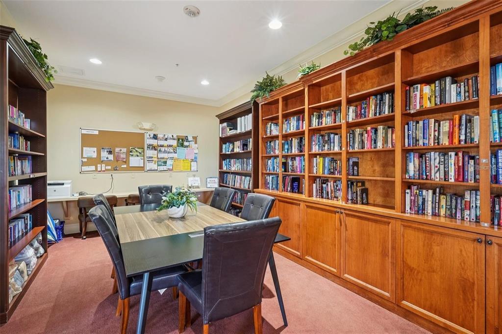 10339 Addison Shore Way Oxford, FL 34484 - Photo 18 of 54 a view of a dining room with furniture and a book shelf