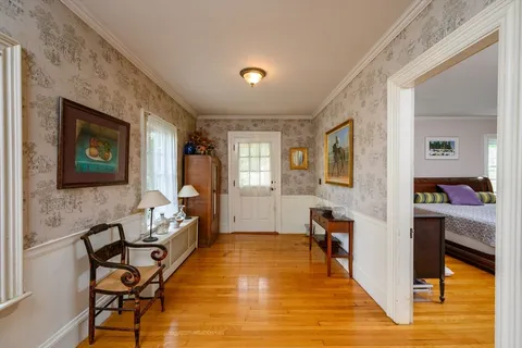 a bedroom with furniture and a wooden floor