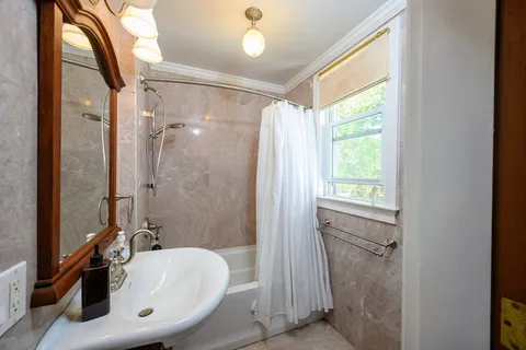 a bathroom with a sink a mirror and a shower