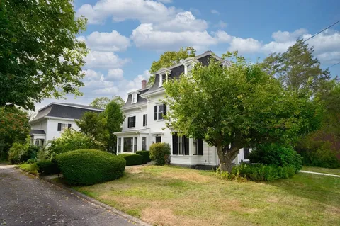 a front view of a house with a garden
