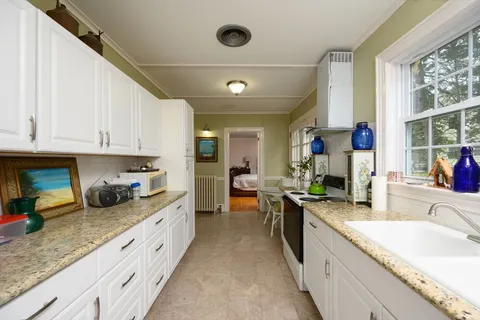 a kitchen with stainless steel appliances granite countertop a sink and cabinets