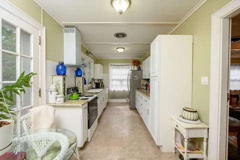 a kitchen with a refrigerator and a sink