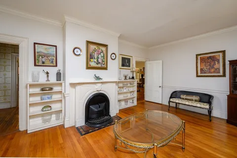a living room with furniture a rug and a fireplace