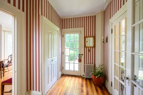 a view of a room with wooden floor and windows