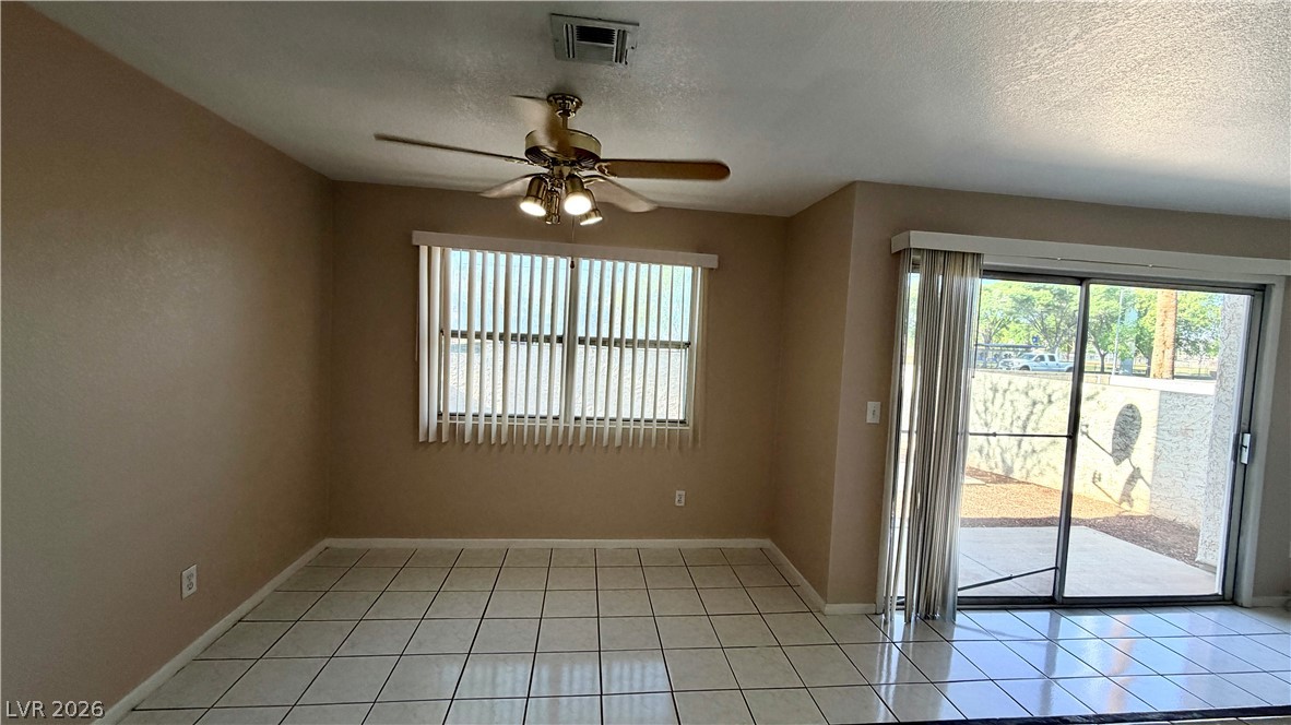 6250 West Flamingo Road, Unit 4 Las Vegas, NV 89103 - Photo 4 of 45 This bright living space features a large window and sliding glass door, offering abundant natural light.