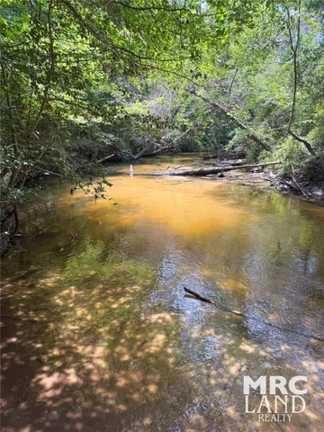 a view of a swimming pool with an outdoor space and seating area