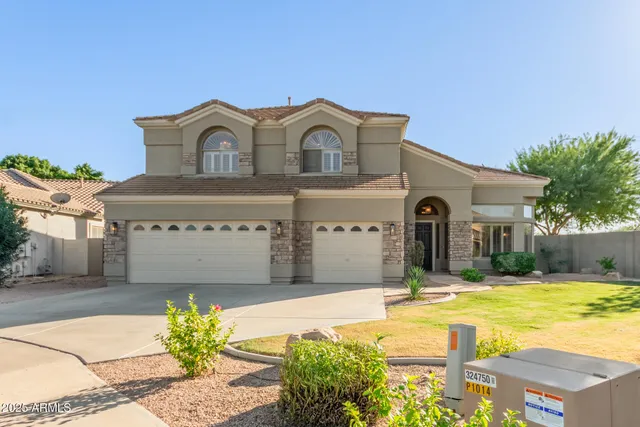 an empty room with wooden floor and a fireplace