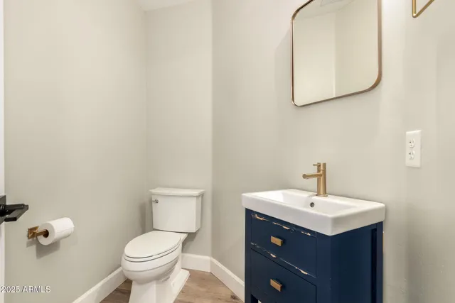 a view of a room with wooden floor and white walls