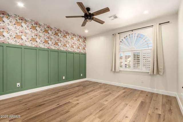a view of a hallway with wooden floor and windows
