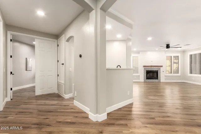 wooden floor fireplace and windows in an empty room