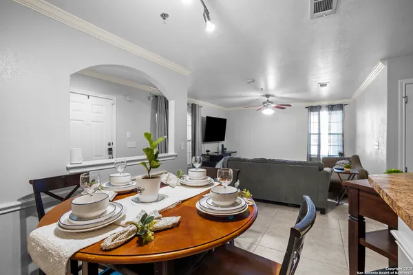 a living room with furniture and a dining table