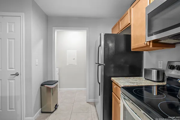a kitchen with stainless steel appliances granite countertop a refrigerator and a stove