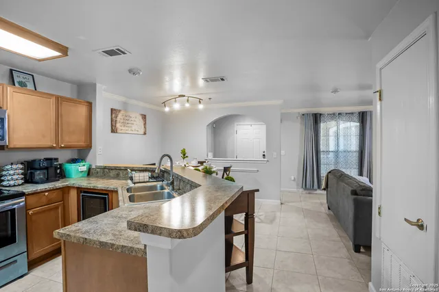 a kitchen with a sink stove and cabinets
