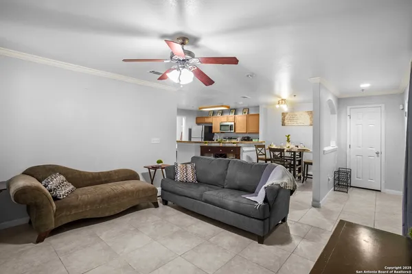 a living room with furniture and a view of kitchen