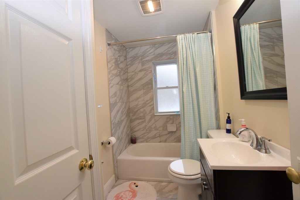 25 Sawin Street, Unit 25 Watertown, MA 02472 - Photo 14 of 22 a bathroom with a sink a toilet a mirror a bathtub and shower
