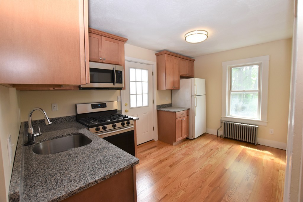 25 Sawin Street, Unit 25 Watertown, MA 02472 - Photo 2 of 22 a kitchen with a stove a sink and a microwave