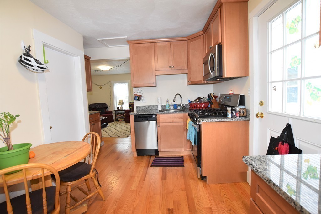 25 Sawin Street, Unit 25 Watertown, MA 02472 - Photo 5 of 22 a living room with stainless steel appliances furniture a rug kitchen view and a window