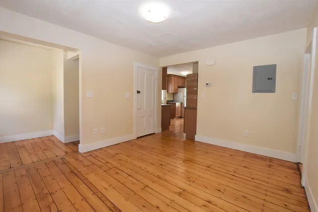 a view of an empty room and wooden floor