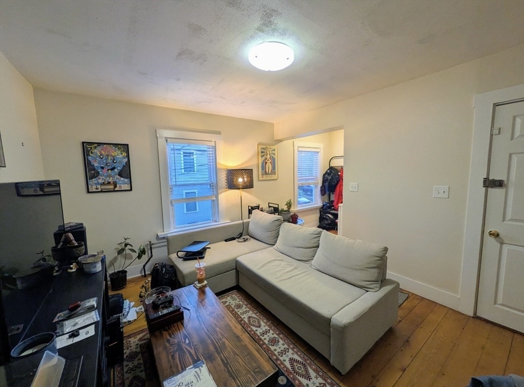 25 Sawin Street, Unit 25 Watertown, MA 02472 - Photo 9 of 22 a living room with furniture or couch and a wooden floor