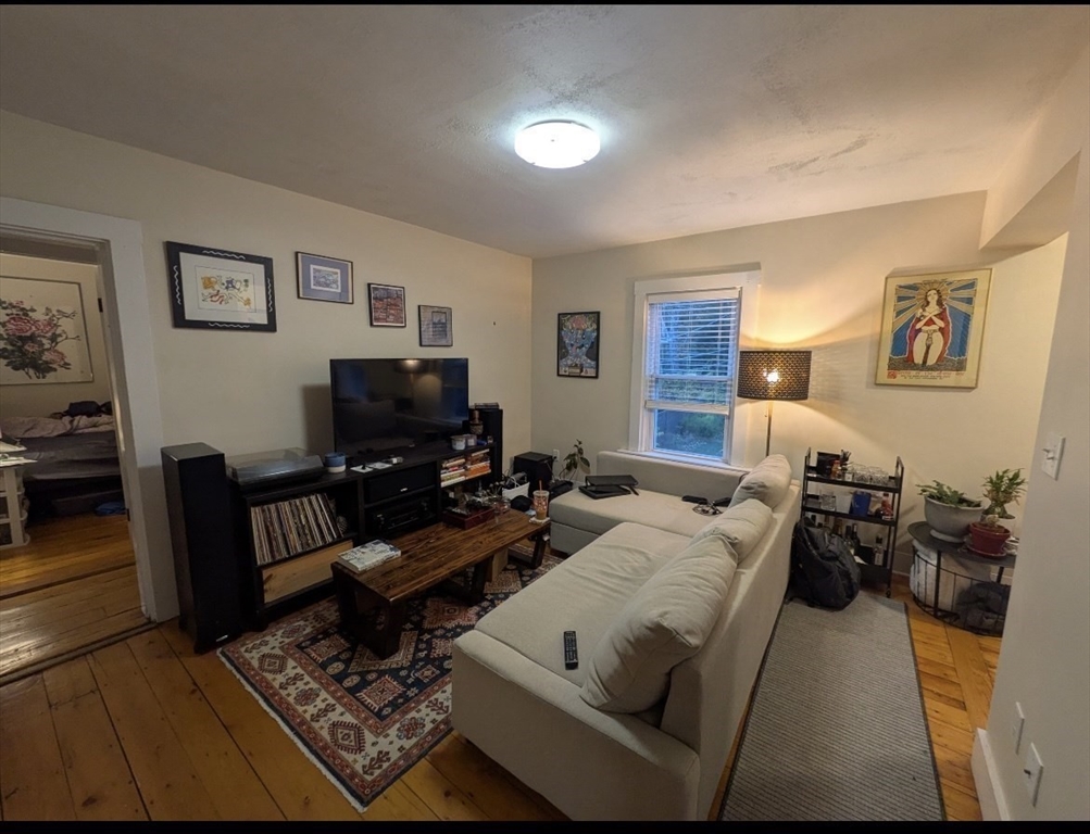 25 Sawin Street, Unit 25 Watertown, MA 02472 - Photo 10 of 22 a living room with furniture and a flat screen tv