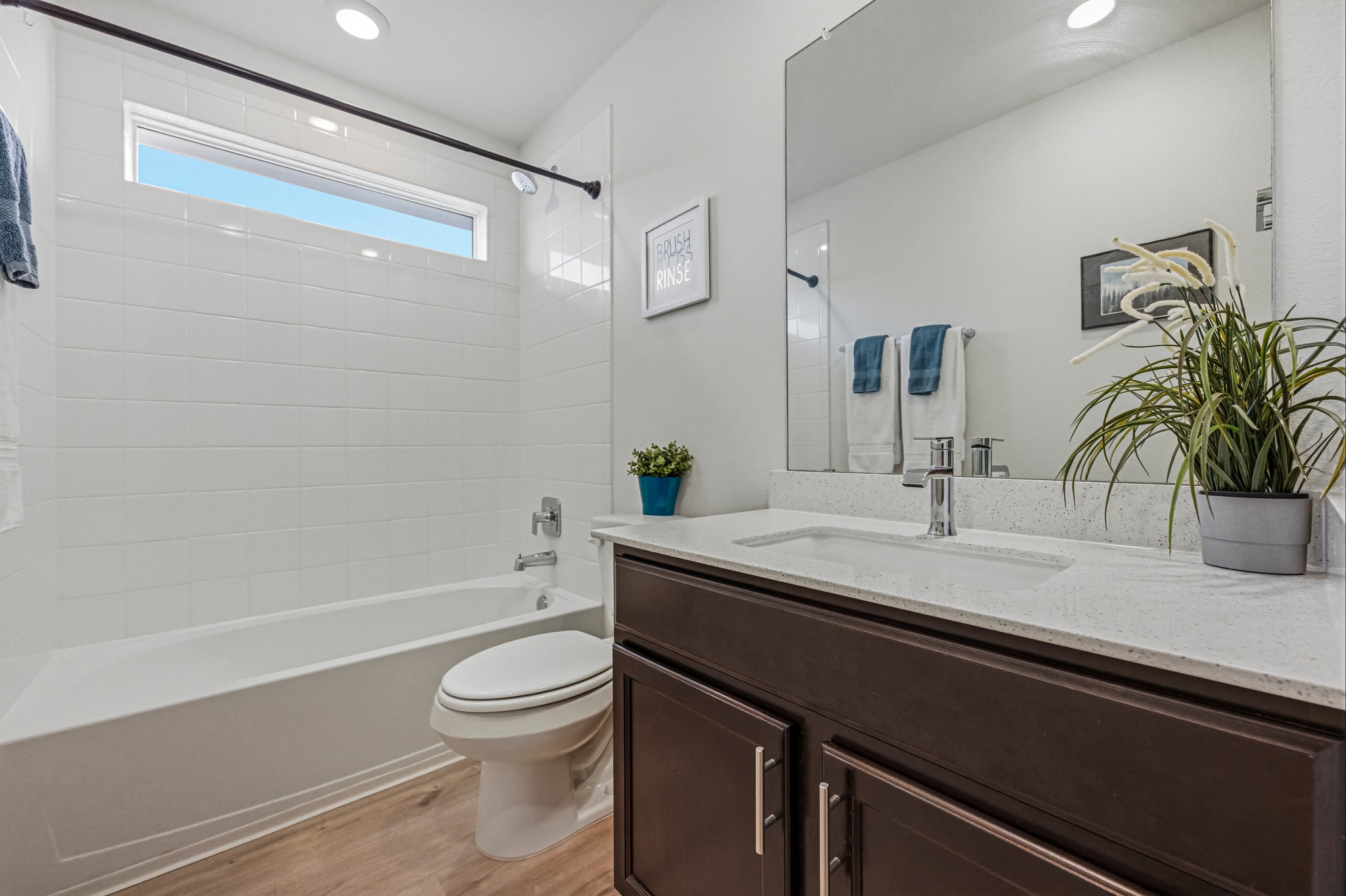 7511 Traylor Cove Austin, TX 78724 - Photo 23 of 40 a bathroom with a granite countertop sink toilet a large mirror a shower and a bathtub
