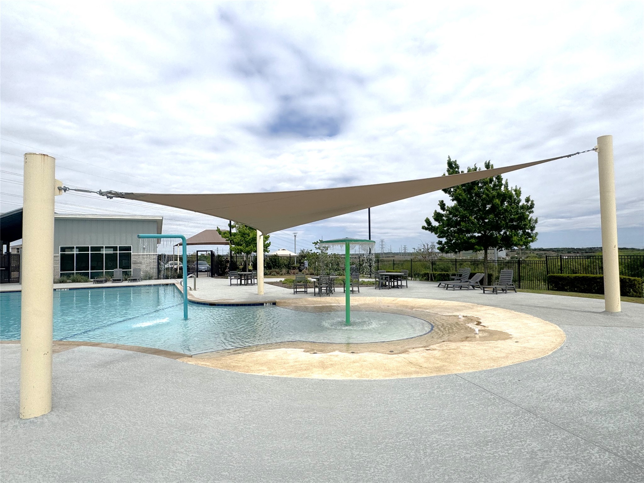 7511 Traylor Cove Austin, TX 78724 - Photo 31 of 40 Community pool with sunshade canopy! Enjoy the splashpad in the shade.