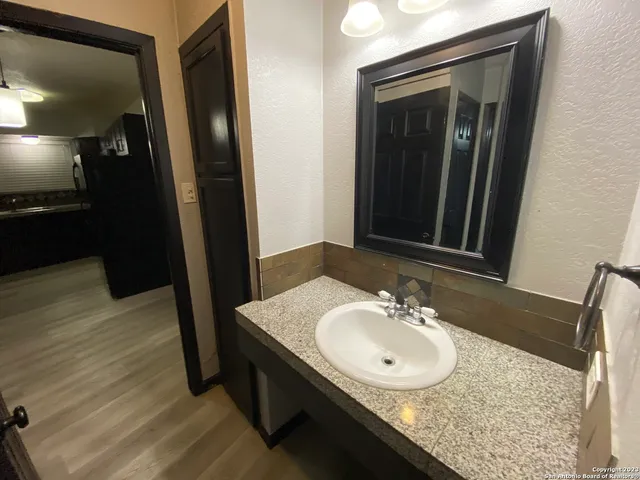 a bathroom with a sink and a mirror