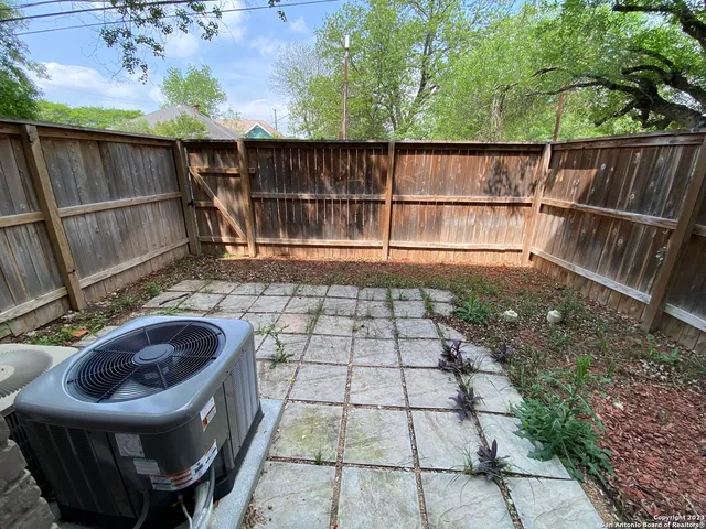 a view of a chair and table in the backyard