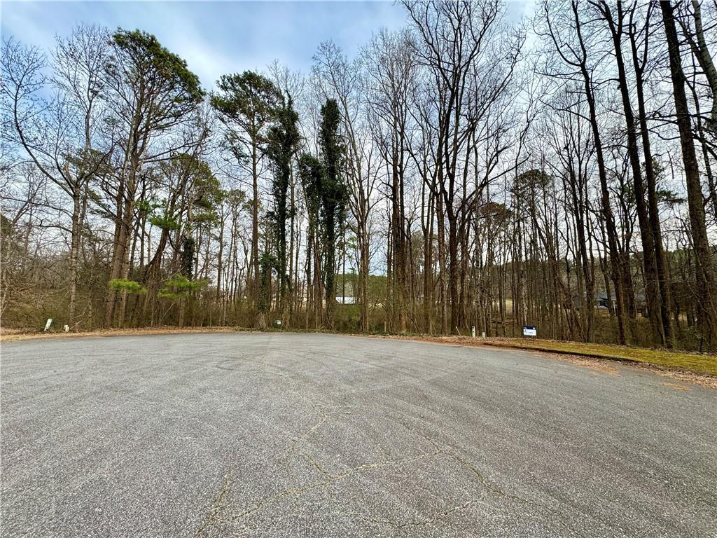 1680 Greystone Road Cumming, GA 30040 - Photo 4 of 9 a backyard of a house with large trees