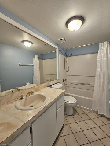 a room with a white cabinets and washer dryer