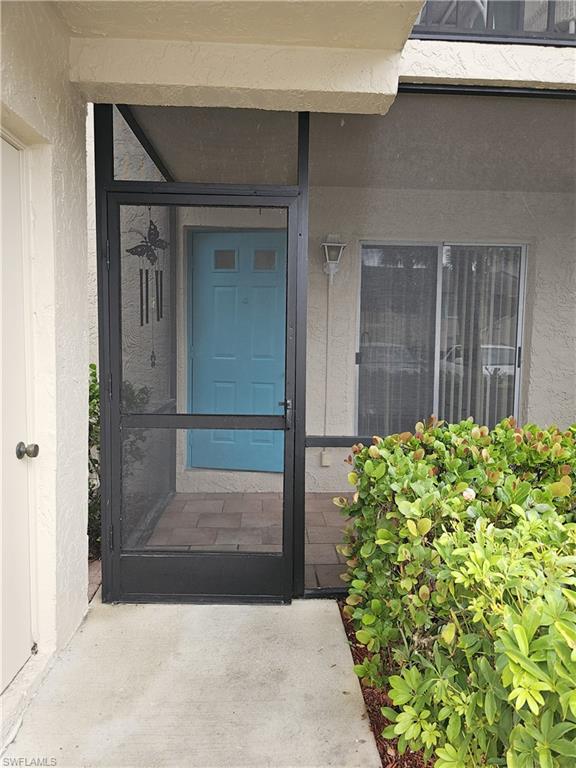 4140 Looking Glass Lane, Unit 5 Naples, FL 34112 - Photo 2 of 24 front view of a house with a yard