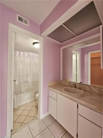 a bathroom with a bathtub shower and toilet