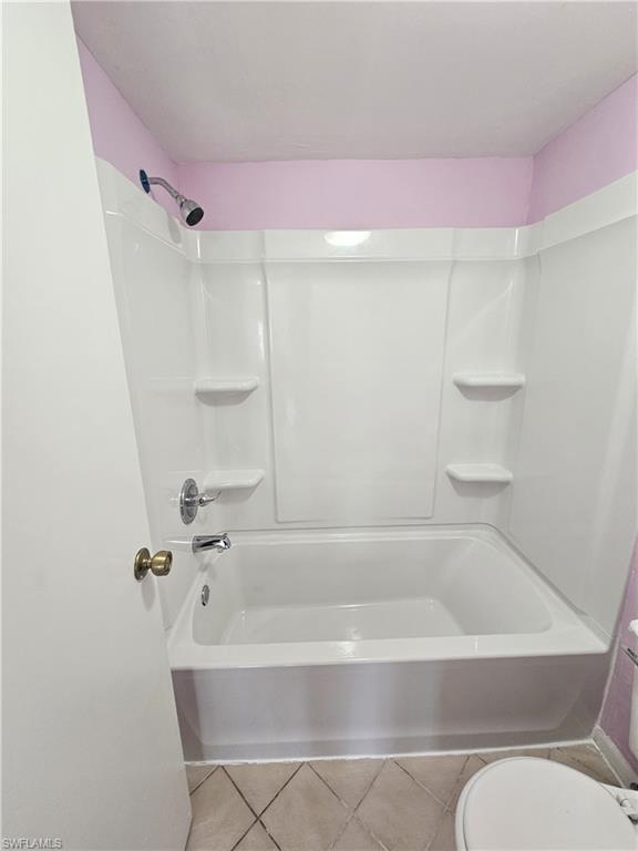4140 Looking Glass Lane, Unit 5 Naples, FL 34112 - Photo 22 of 24 a bathroom with a bathtub shower and toilet