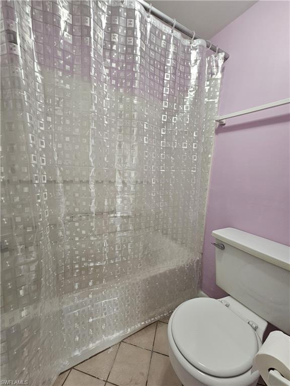 4140 Looking Glass Lane, Unit 5 Naples, FL 34112 - Photo 23 of 24 a white toilet sitting next to a bath tub