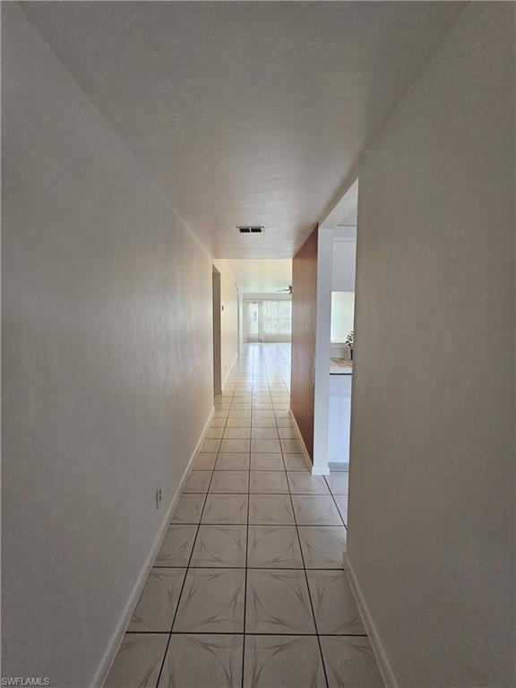 4140 Looking Glass Lane, Unit 5 Naples, FL 34112 - Photo 5 of 24 a view of an empty room and window