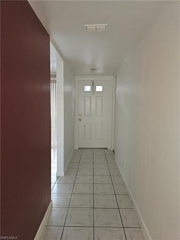 4140 Looking Glass Lane, Unit 5 Naples, FL 34112 - Photo 6 of 24 wooden floor in an empty room with a window