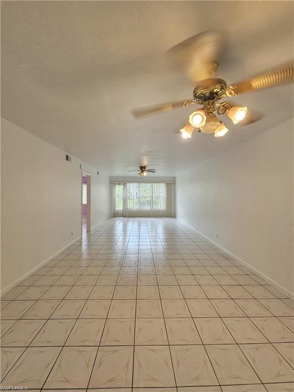 4140 Looking Glass Lane, Unit 5 Naples, FL 34112 - Photo 7 of 24 a view of an empty room and chandelier fan