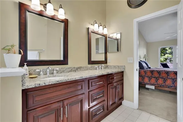 a spacious bathroom with a tub sink and mirror