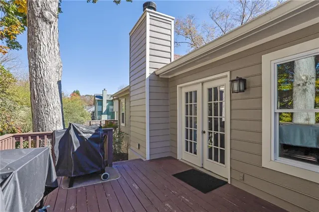 a view of backyard with deck and a garden