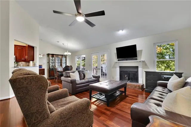 a living room with furniture a fireplace and a flat screen tv